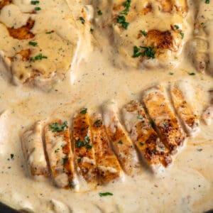 Overhead, look at sliced creamy ranch chicken in a skillet.