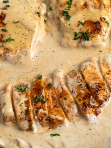 Overhead, look at sliced creamy ranch chicken in a skillet.