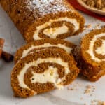 Three pieces of pumpkin roll stack on top of each other.