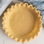 Overhead, look at a uncooked flaky butter pie crust.