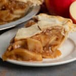 Close-up of a slice homemade apple pie on a plate.