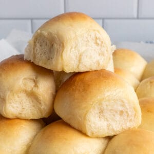 Homemade dinner rolls stacked on top of each other.