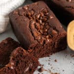 Chocolate bread with two slices cut off in front of the rest of the chocolate loaf.