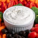 Cottage cheese ranch dip in the middle of cut up veggies.