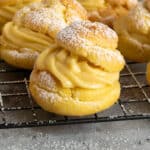 Close-up of custard puffs on a wire cooling rack