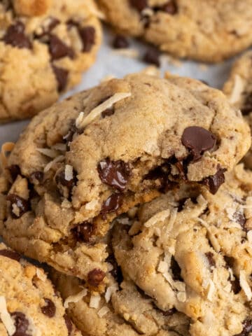 Coconut chocolate chip cookies with a bite taken out of it.