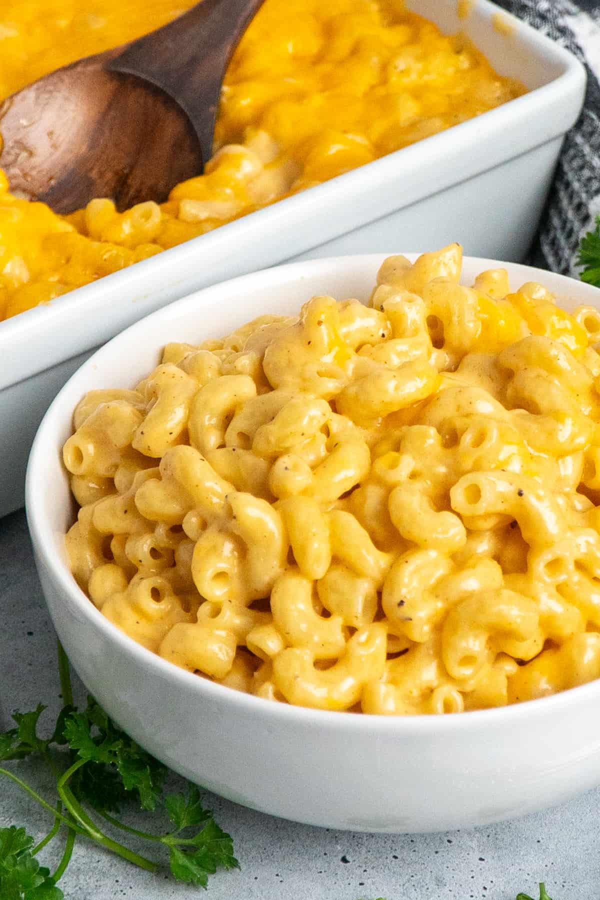 Side view of a white bowl full of mac and cheese.