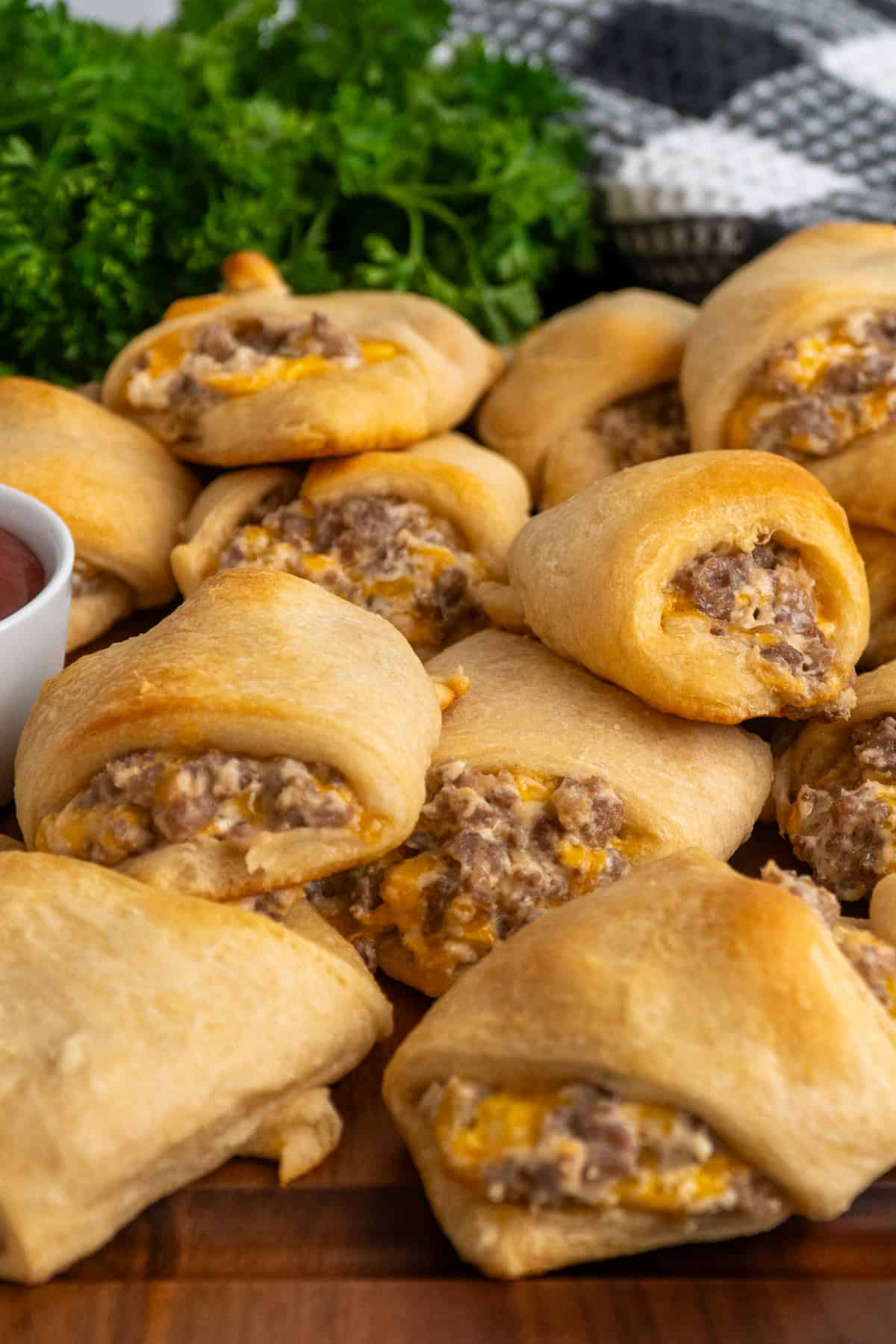 Sausage cream cheese crescent rolls stacked on top of each other.