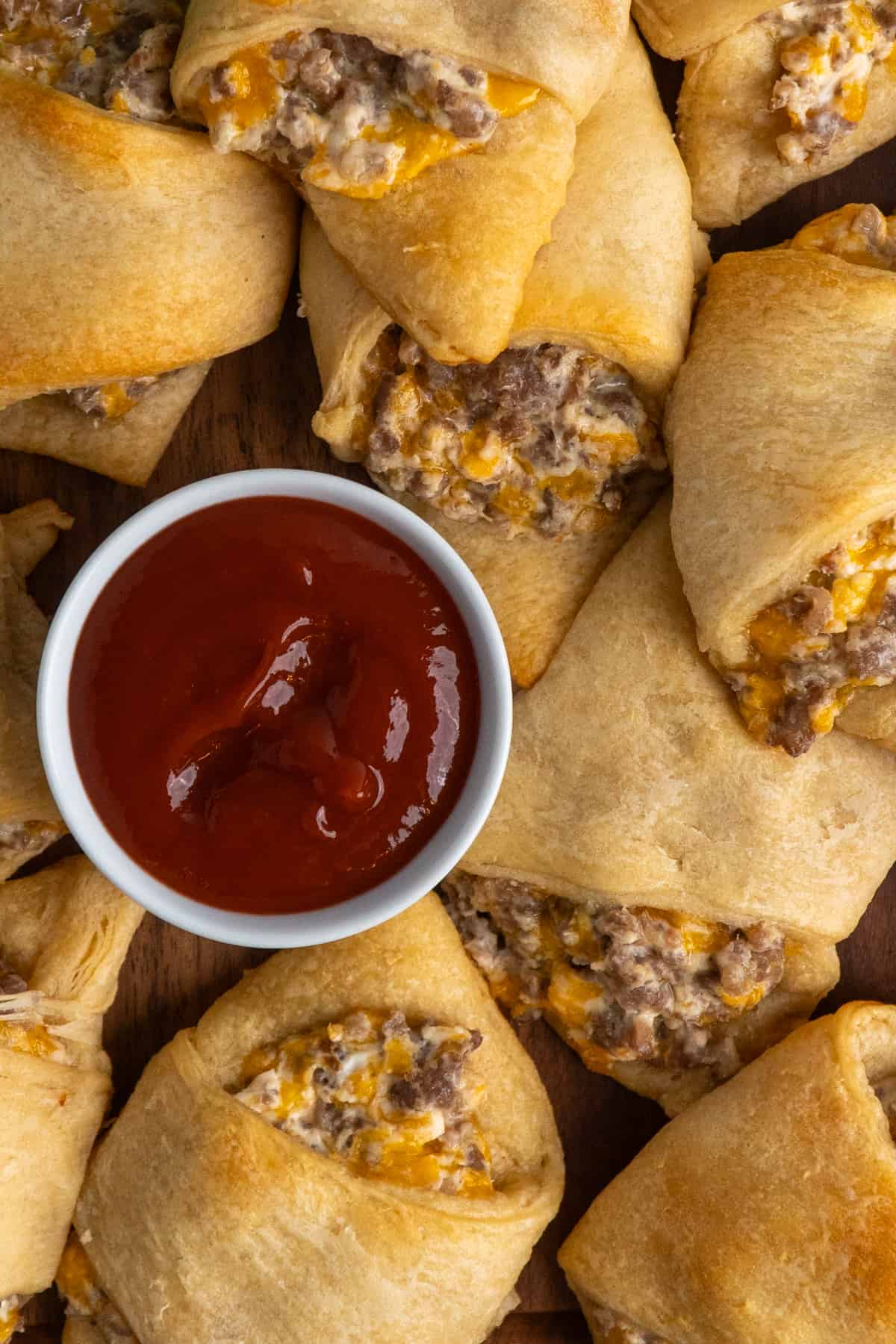 Overhead look at sausage cream cheese crescent rolls with ketchup.