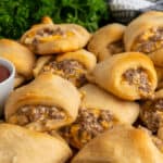 Sausage cream cheese crescent rolls stacked on top of each other.