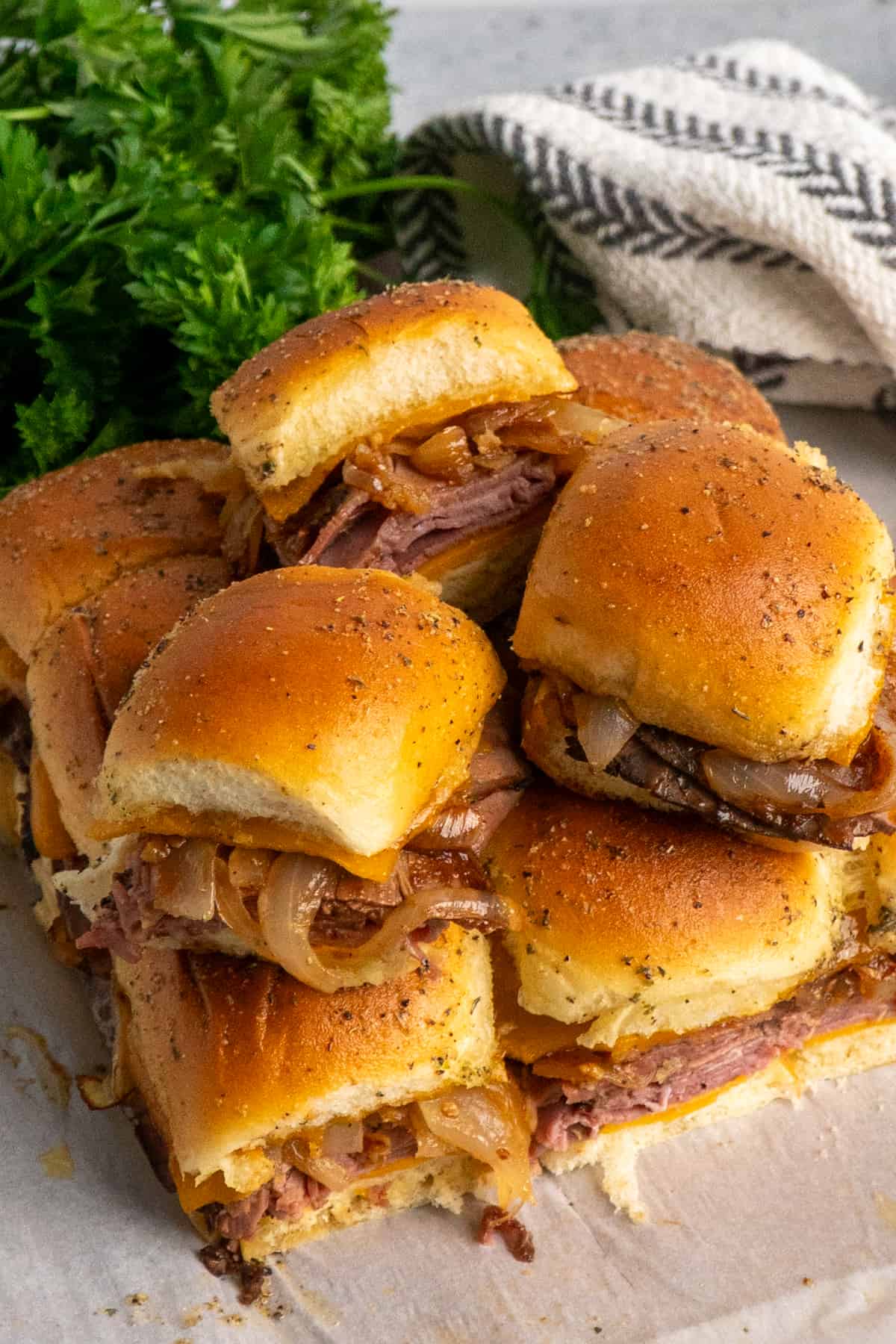 Overhead look at roast beef sliders stacked on top of each other.