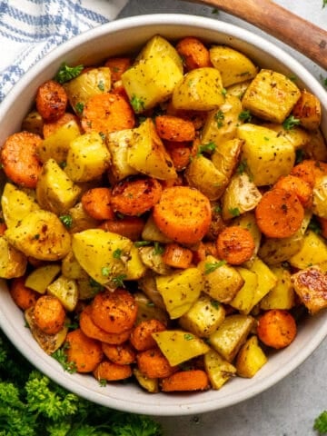 Roasted potatoes and carrots in a bowl.