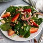 Close up of strawberry spinach salad on a plate.