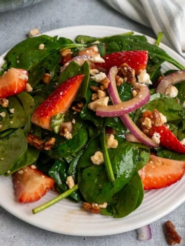 Close up of strawberry spinach salad on a plate.