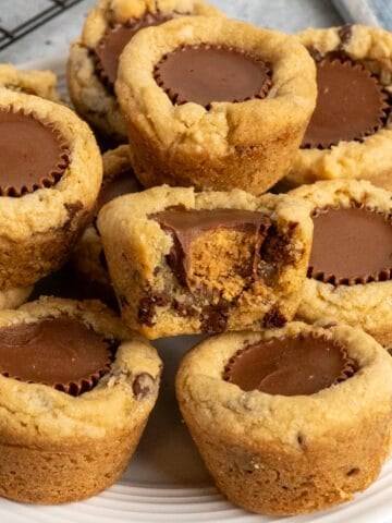 Chocolate chip peanut butter cups stacked up on a plate.