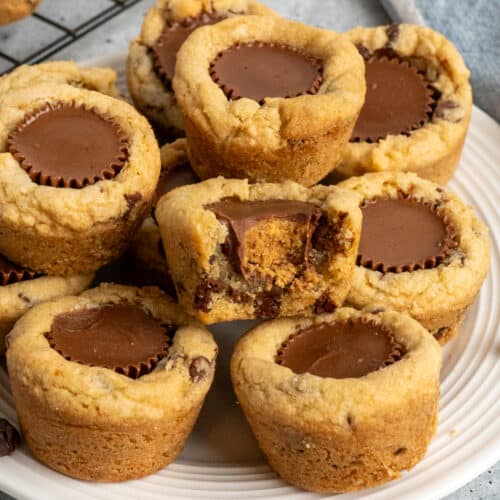 Chocolate chip peanut butter cups stacked up on a plate.