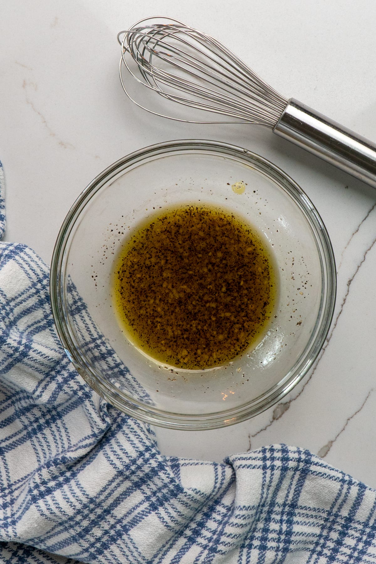 Homemade vinaigrette in a clear bowl.