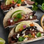 Close up of three flank steak tacos.