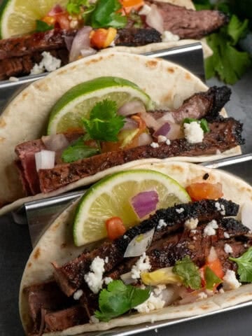 Close up of three flank steak tacos.