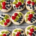 Close up of a fruit pizza cookies on a cooling rack.