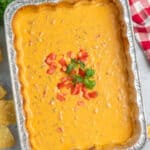 Overhead look at smoked queso dip in a aluminum baking dish.