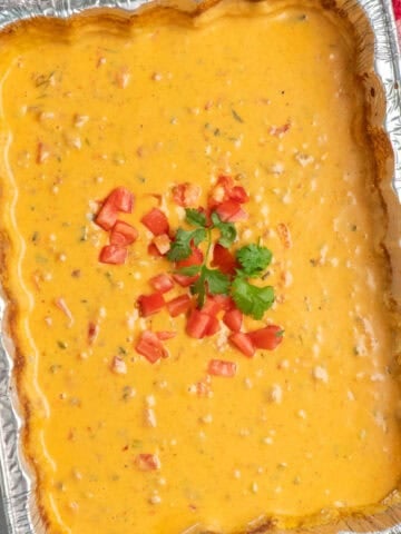 Overhead look at smoked queso dip in a aluminum baking dish.