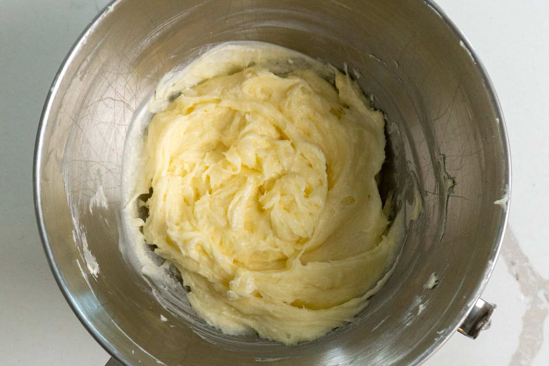 Cream cheese filling in a metal mixing bowl.