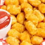 Close up of tater tots stacked on top of each other.