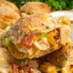 Close up of chicken bacon ranch sliders stacked on top of each other.
