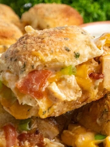 Close up of chicken bacon ranch sliders stacked on top of each other.