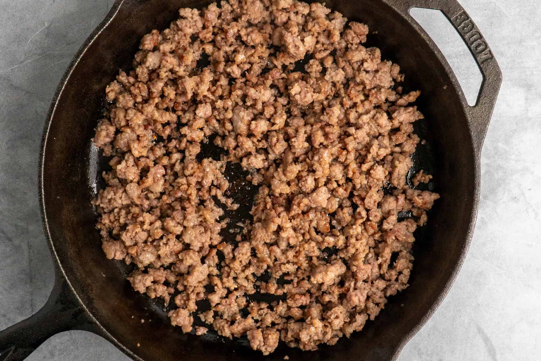 Browned sausage in a cast iron skillet.