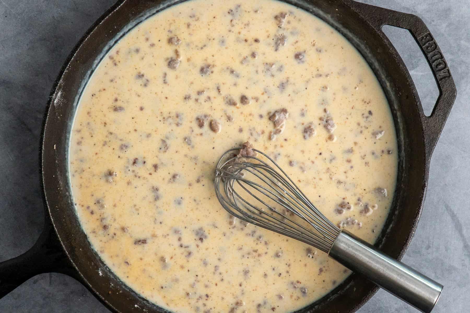 Milk added into sausage and flour mixture.
