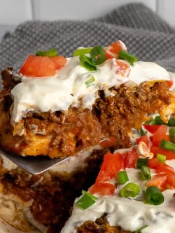 A spatula holding a slice of taco pie.