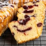 Cranberry bread sliced and ready to serve on a baking rack.
