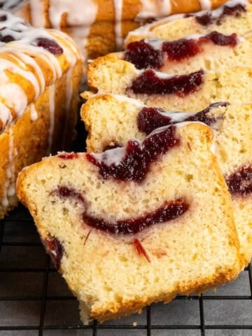 Cranberry bread sliced and ready to serve on a baking rack.