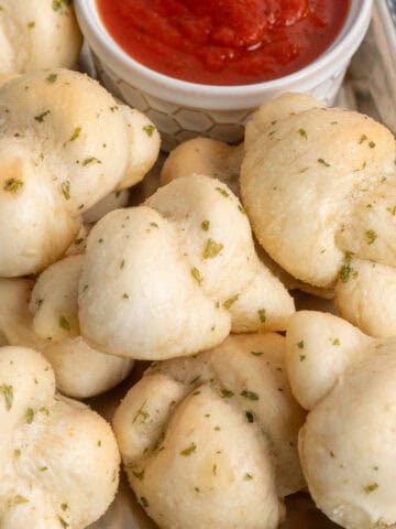 Garlic Knots on a tray with dipping sauce.