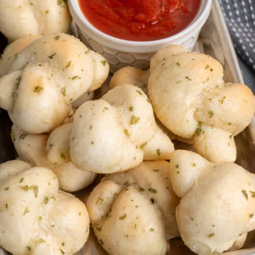 Garlic Knots on a tray with dipping sauce.
