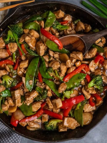 Teriyaki chicken stir fry in a cast iron skillet.