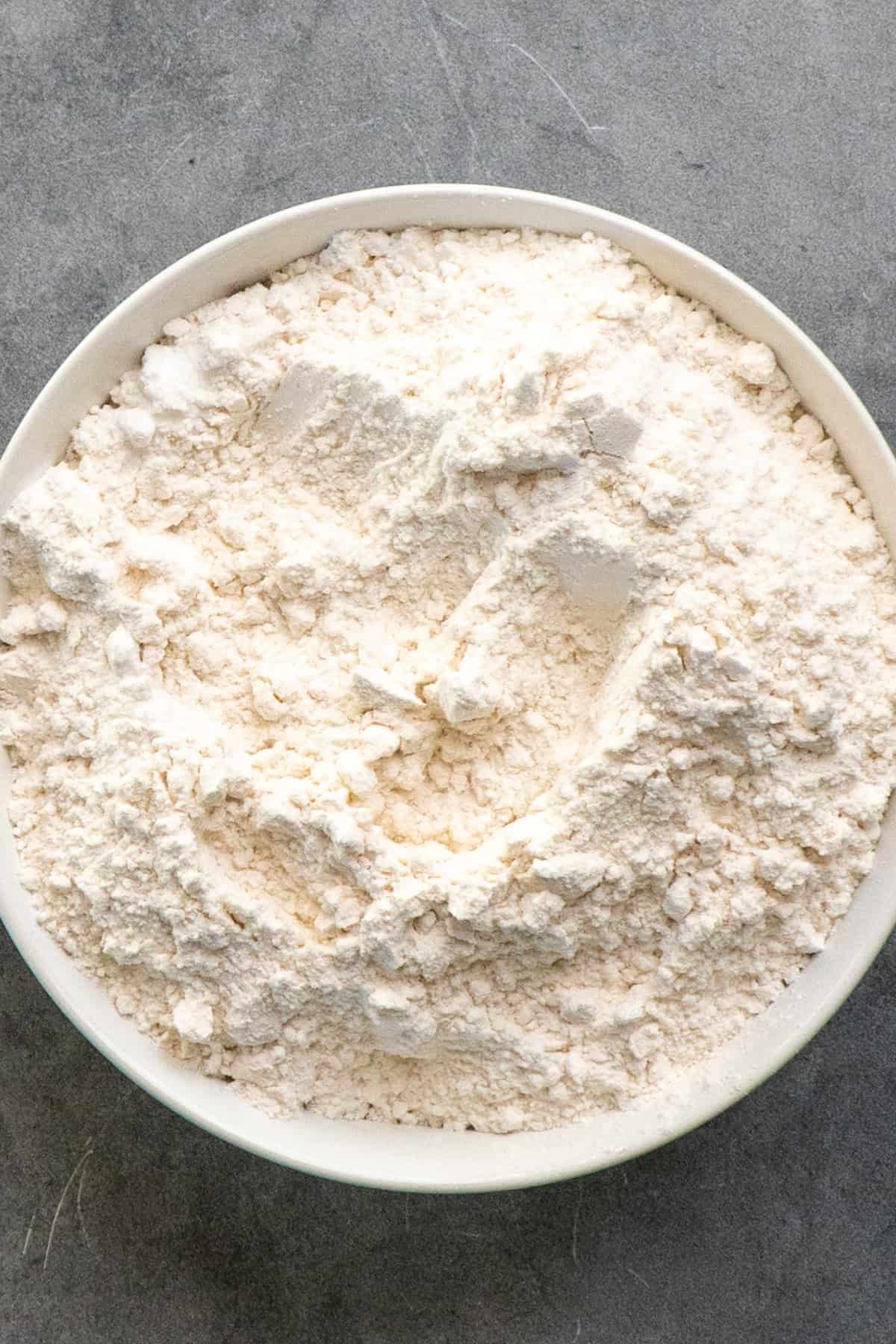 Dry ingredients whisked together in a white bowl.