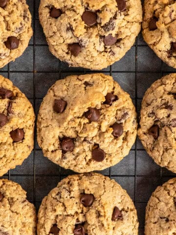 Oatmeal chocolate chip cookies on a wire cooling rack.