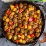 Sweet and sour meatballs in a cast iron skillet.