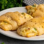 Three chicken crescent rolls on a plate.