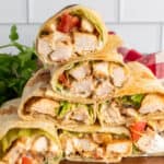 Grilled chicken wraps stacked on top of each other.