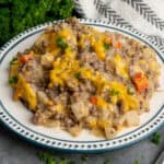 Hobo casserole on a plate with parsley in the background.