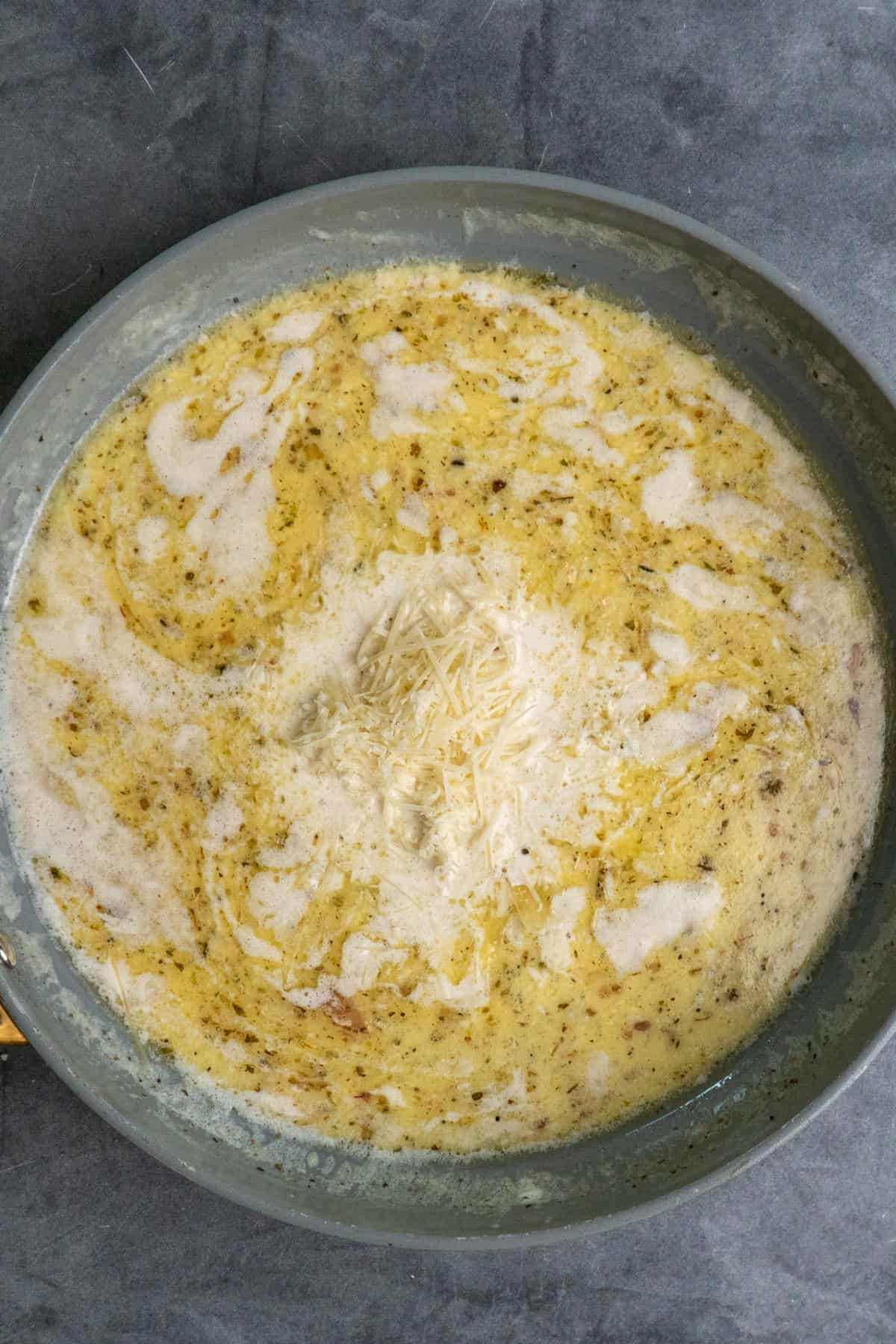 Half and half and parmesan added to the skillet.