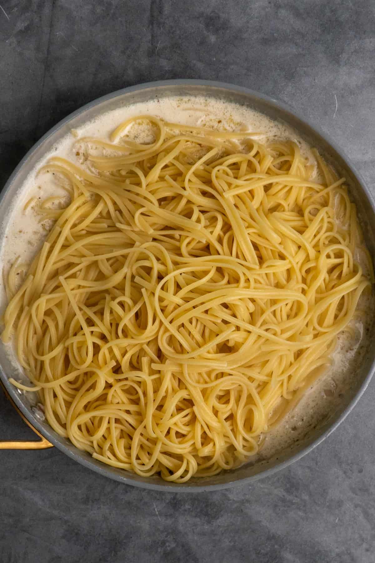 Cooked pasta added to the skillet.