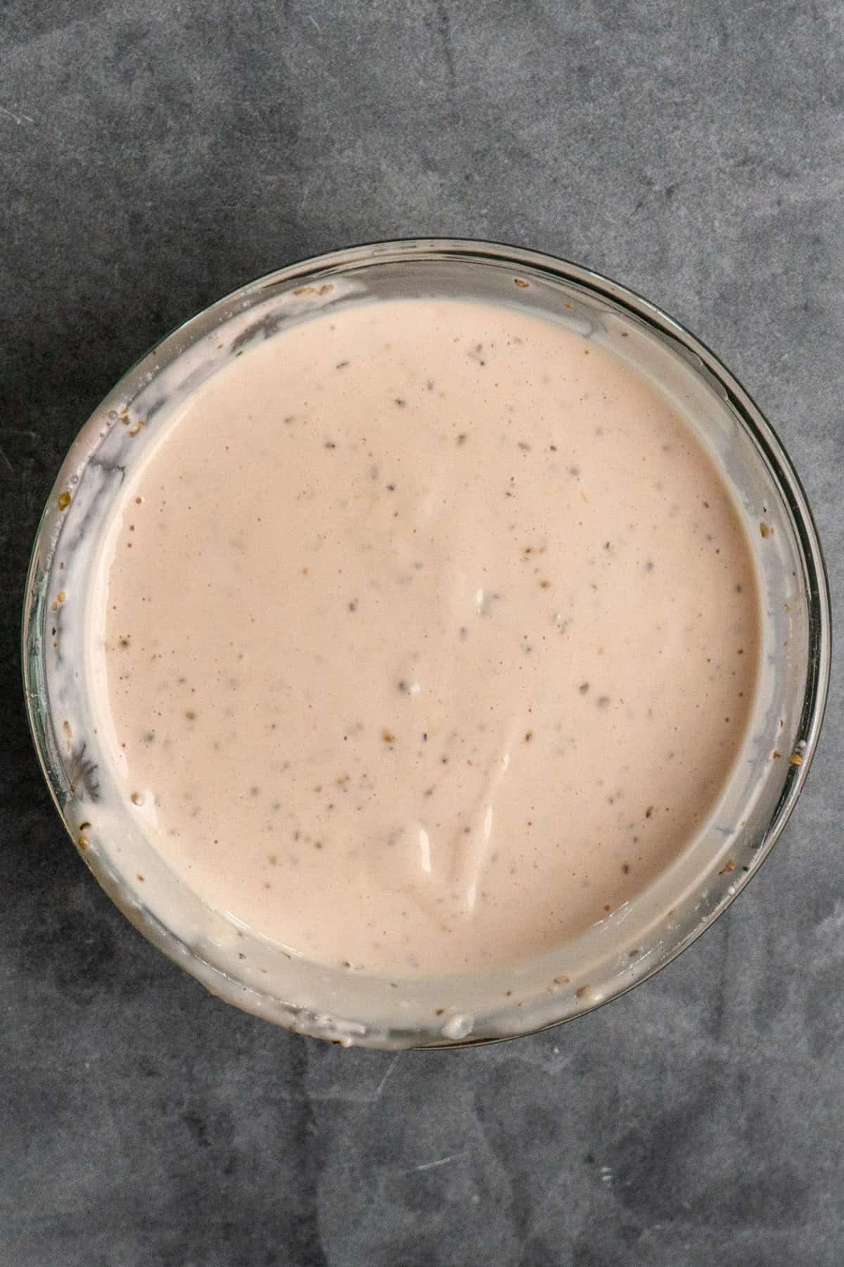 Ingredients for grinder sauce mixed together in a clear bowl.