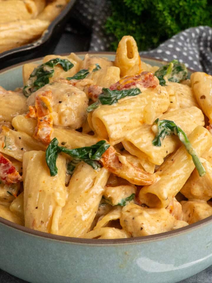 Marry me chicken pasta in a bowl with more in a skillet.