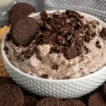 Oreo fluff in a white bowl with Oreo cookies around it.