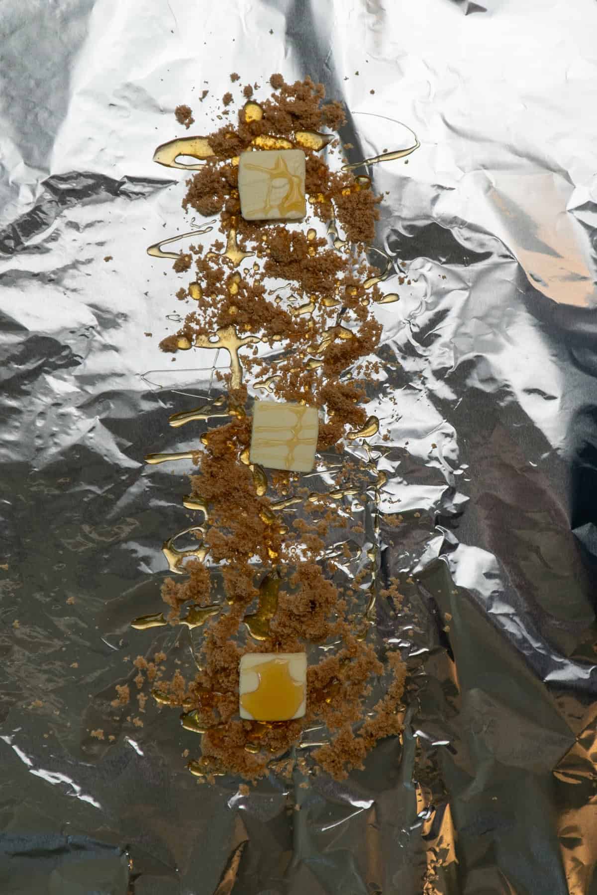 Honey, brown sugar, and butter on aluminum foil ready for the ribs to be wrapped up.